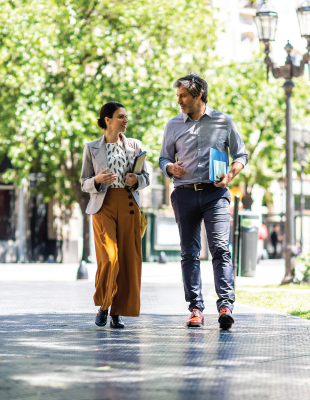 two colleagues talking while walking at the park