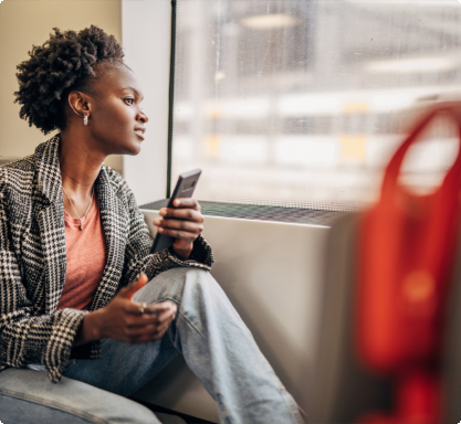 Woman holding a phone in transit